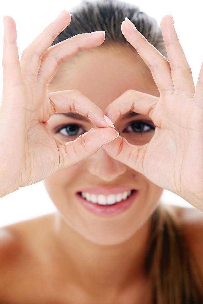 Beautiful woman is posing over a white background